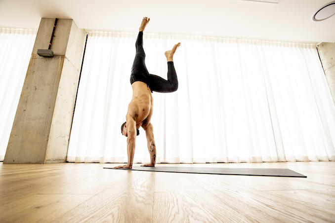 Man doing handstand in yoga