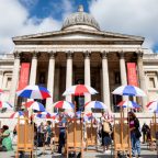 The National Gallery London from the front with umbrellas and tables spread out in Trafalgar Square