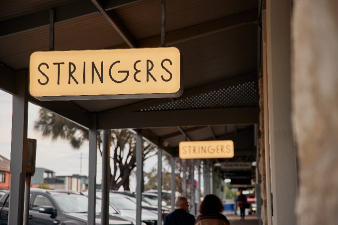 A photo of the Strings Sorrento sign on the main street