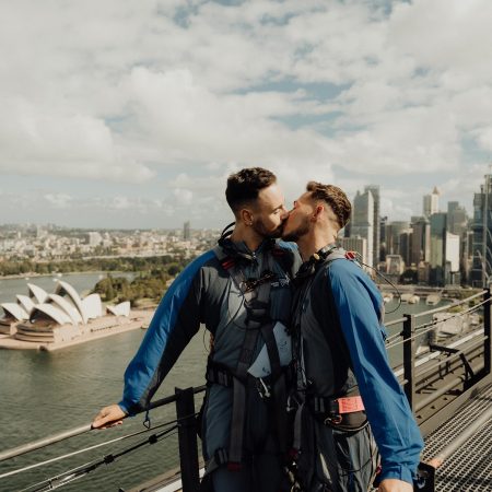 Two men kissing atop Sydney Harbour Bridge