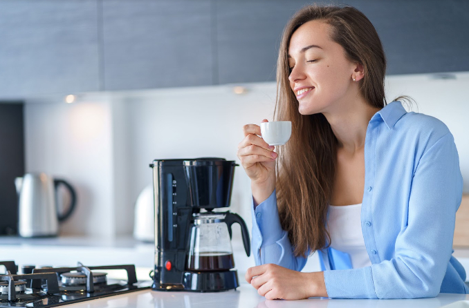 Woman coffee machine cup