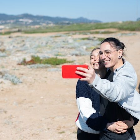 Non binary couple selfies travel caravan desert