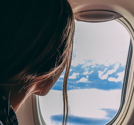 Woman girl aeroplane plane window flying travel
