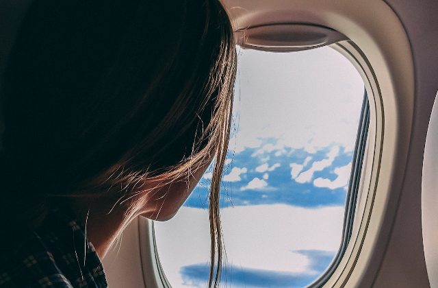 Woman girl aeroplane plane window flying travel