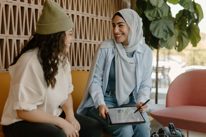 Women smiling ipad computer work hijab muslim